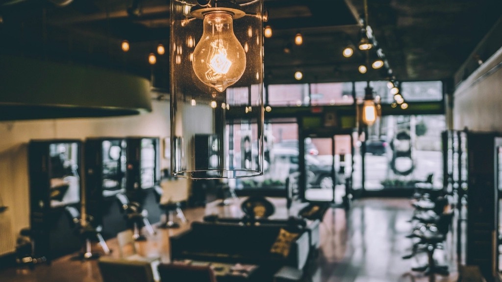 Inside a warmly lit barbershop with a row of chairs